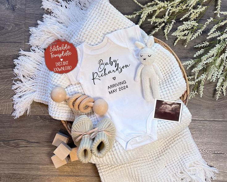 a baby's first christmas outfit and other items laid out on a wooden floor