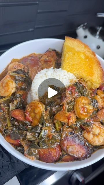 a white bowl filled with meat and vegetables on top of a stove next to a piece of bread