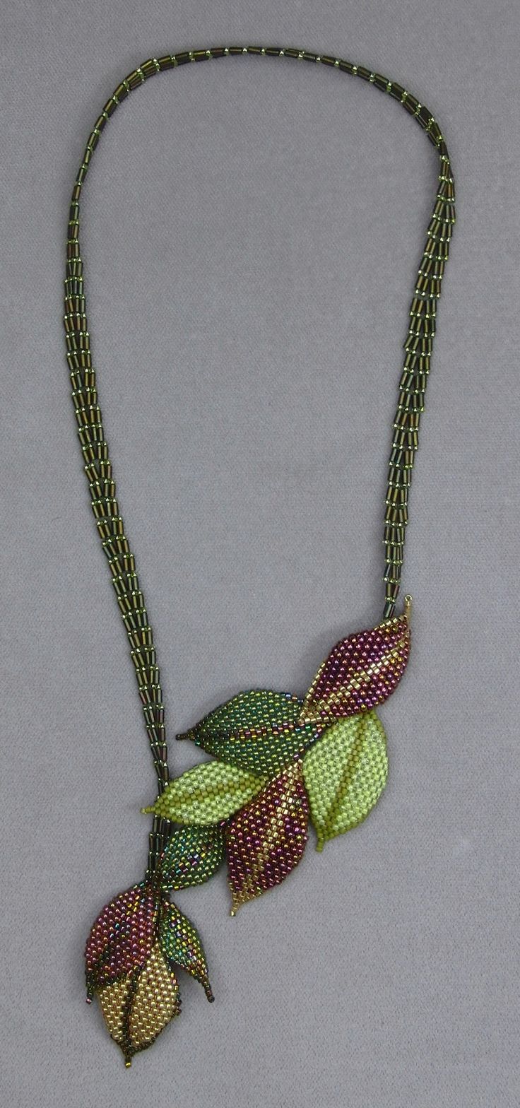 a green and red necklace with leaves on it