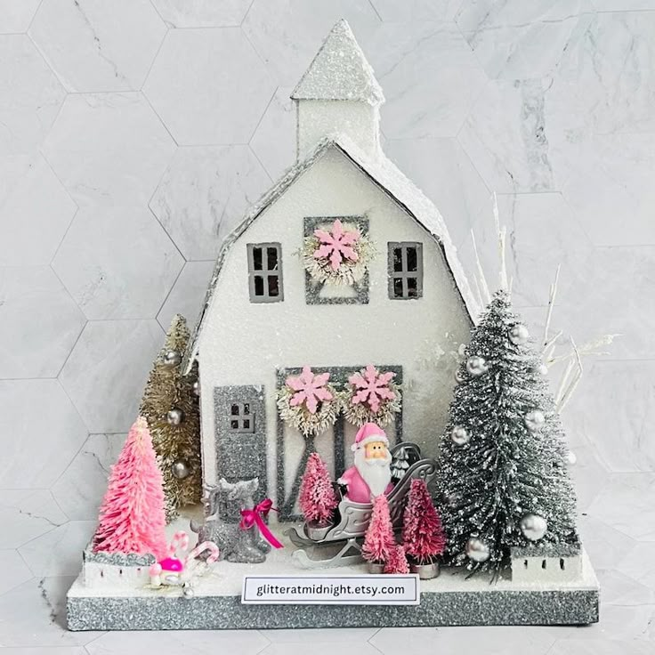 a white house with pink decorations and trees