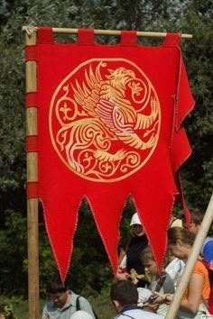 a group of people sitting around a red flag