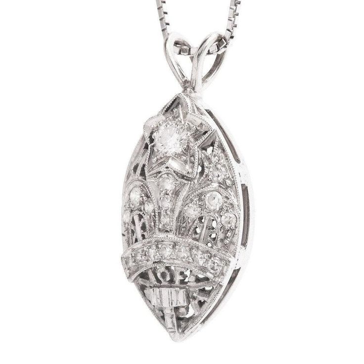 This beautiful pendant is a striking combination of filigree and diamonds, and though it's relatively large (30mm x 13mm), the filigree and the cutouts help create a delicateness. At the top of the pendant is a 3.2mm diamond set into the middle of a white gold star. Ideally suited to hang from a white gold chain (not included), this pendant is a real conversation starter! The design is attributed to the Amaranth Matron, which is the highest rank in the Order of the Eastern Star, an organization Luxury Filigree Diamond Necklace For Formal Occasions, Oval Diamond Necklace With Intricate Design, Luxury Oval Necklace With Intricate Design, Diamond Filigree Pendant Jewelry, Filigree Diamond Pendant Jewelry, Luxury Silver Diamond Filigree Necklace, Luxury Silver Filigree Diamond Necklace, Oval Diamond Filigree Necklace, Heirloom Diamond Necklace With Intricate Design