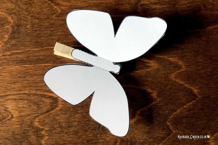 a paper flower cut out on top of a wooden table