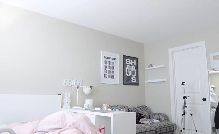 a bedroom with a bed, desk and chair in it