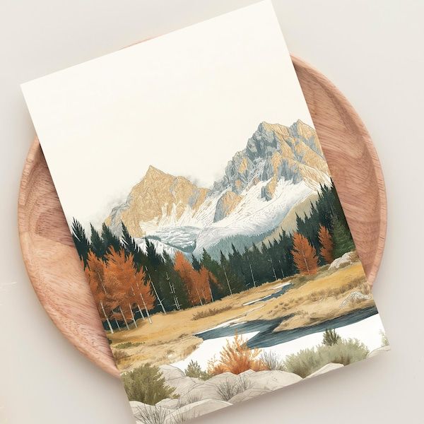 a wooden plate holding a card with a painting of mountains and trees in the background