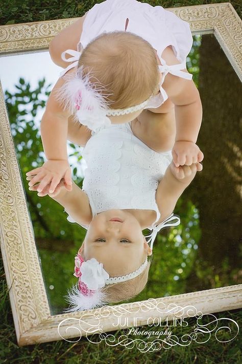 an image of a baby in front of a mirror with the caption's name on it