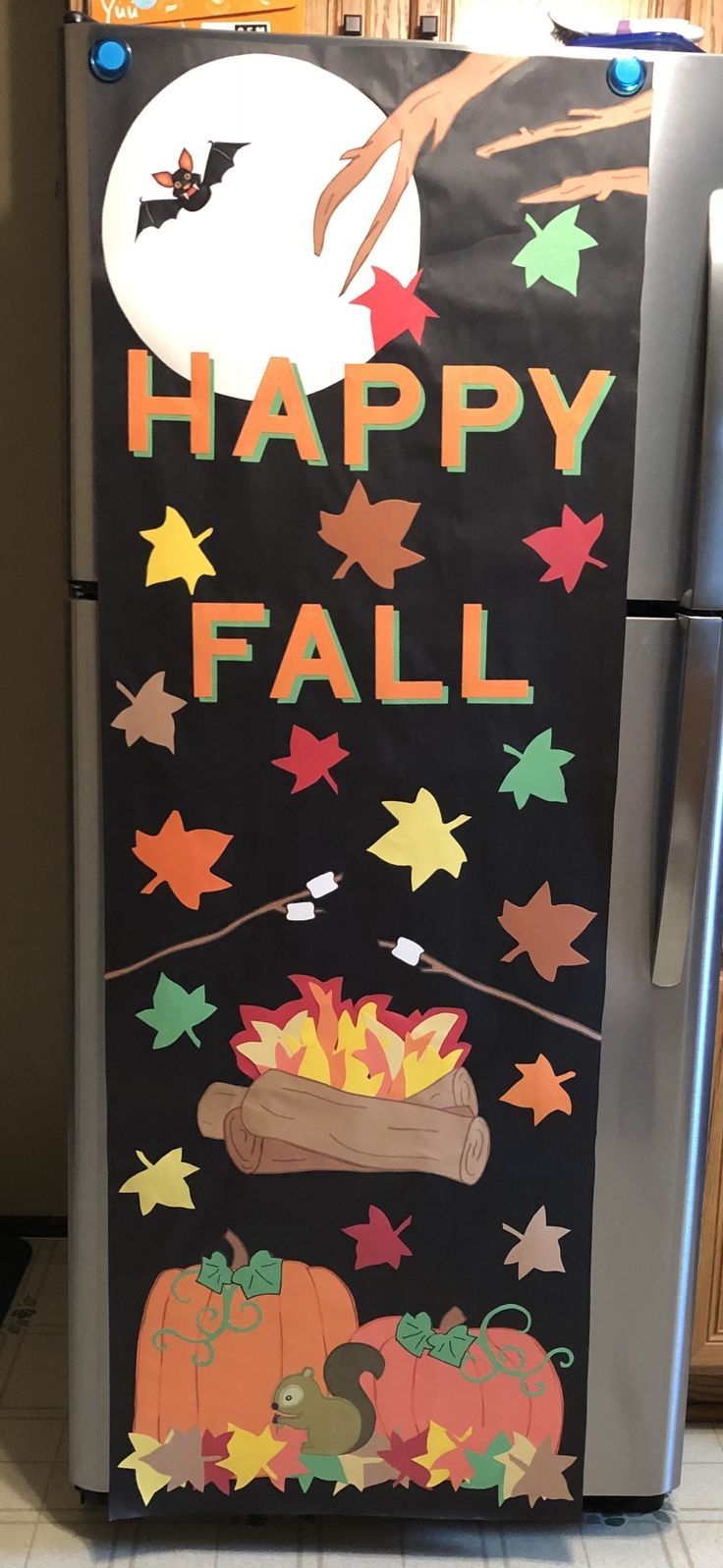 a refrigerator decorated with halloween decorations and the words happy fall