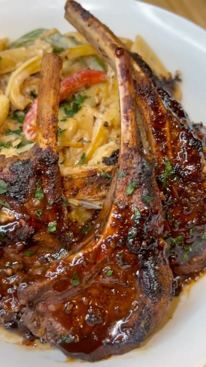 a white plate topped with meat and pasta