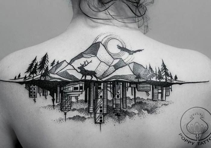 the back of a woman's shoulder with birds and mountains on it, in black and white