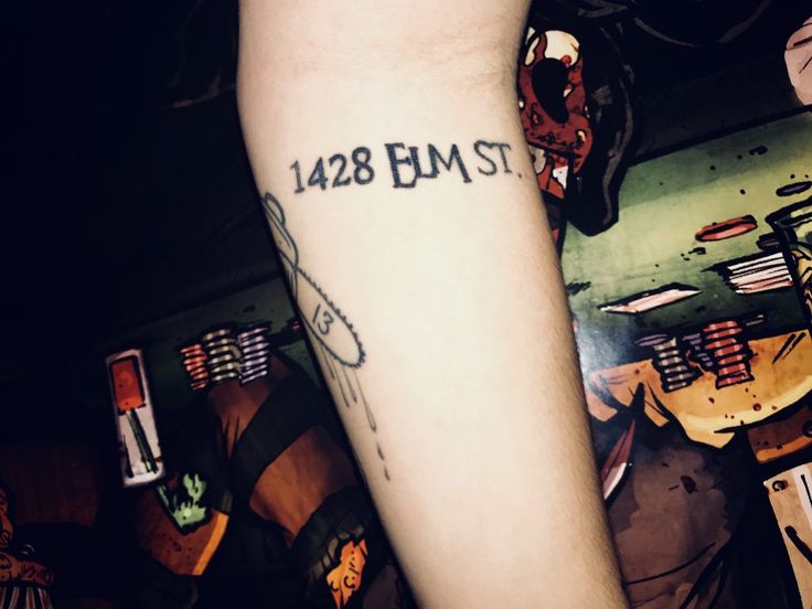 a person's arm with a tattoo that reads 123 bm st on it