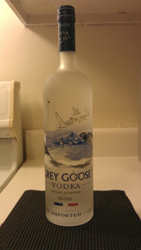 a bottle of grey goose vodka sitting on top of a counter