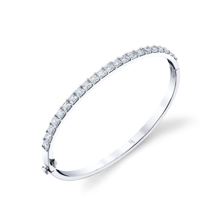 This hinged bangle with Asscher cut diamonds showcases the natural beauty of the stones. Its hinge-style design allows for versatile wear, making it perfect for everyday wear. The bangle is polished to perfection showcasing each facet of the Asscher cut diamond. Timeless Diamond Cut Bangle Jewelry, Channel Set Round Cut Diamond Bracelet, Fine Jewelry Diamond White Diamond Bracelet With Channel Set, Diamond White Channel Set Diamond Bracelet, Classic Emerald Cut Diamond Bracelet With Accents, Fine Jewelry Diamond Bracelet With Channel Set, Channel Set Diamond Bracelet In Fine Jewelry Style, Formal Emerald Cut Diamond Bracelet With Single Cut Diamonds, Modern White Gold Bangle With Single Cut Diamonds