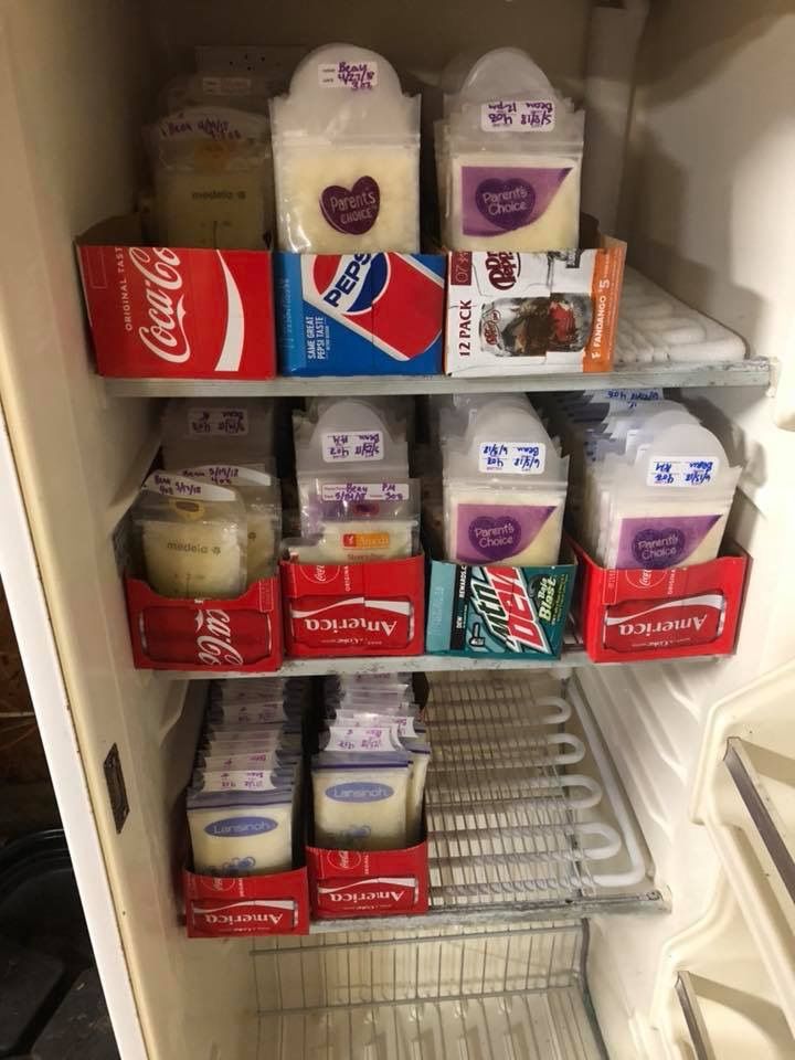 an open refrigerator filled with lots of milk and other food items in it's shelves