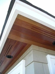 the top of a house with wood paneling on it