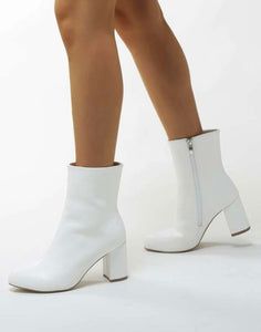 White Leather Ankle Booties White Pointed Toe Platform Boots For Fall, White Pointed Toe Platform Boots In Faux Leather, White Heeled Boots With Round Toe For Spring, Elegant White Leather Platform Boots, White High Heel Faux Leather Boots, White Faux Leather High Heeled Boots, White High Heel Mid-calf Boots For Party, White Fitted Mid-calf Boots With Round Toe, White High Heel Mid-calf Boots Medium Width