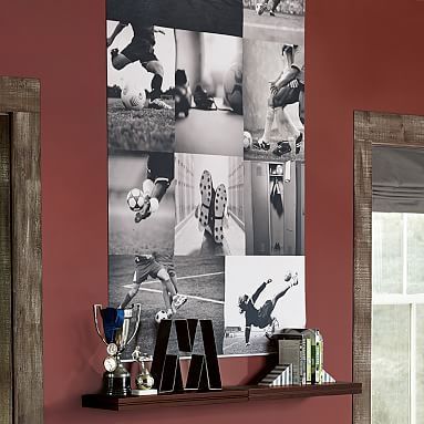 a living room with red walls and pictures hanging on the wall, along with bookshelves