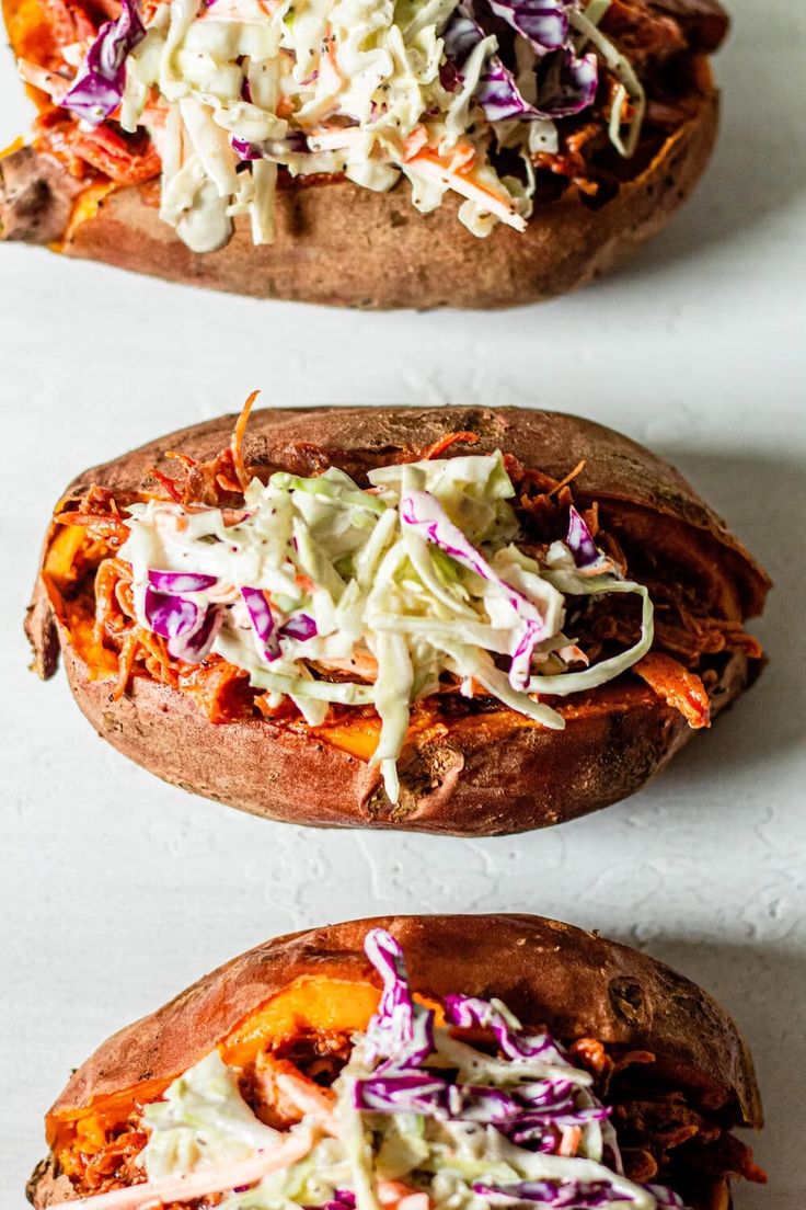 two stuffed sweet potatoes with cole slaw on top