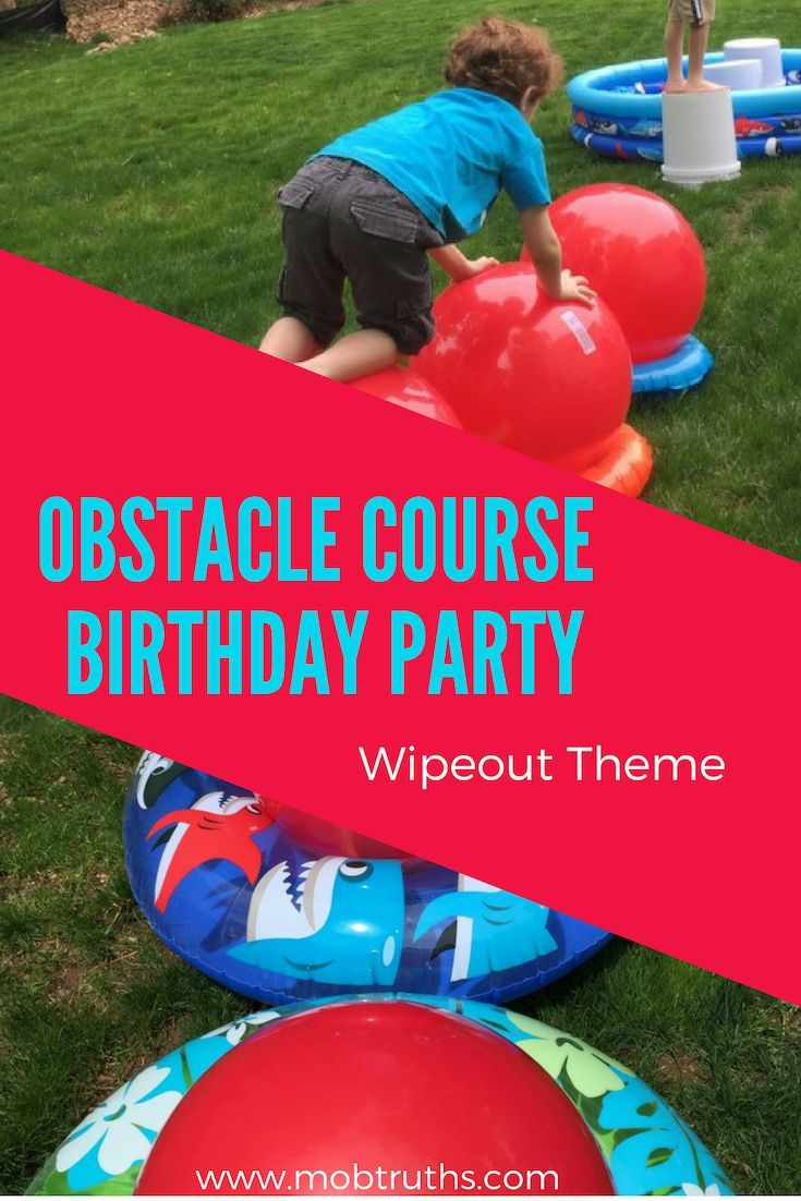 kids playing with inflatable balls on the grass at an obstacle course birthday party