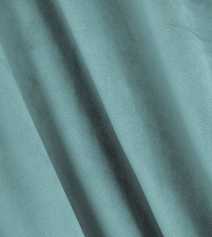 a close up view of a blue curtain with the light reflecting off it's side