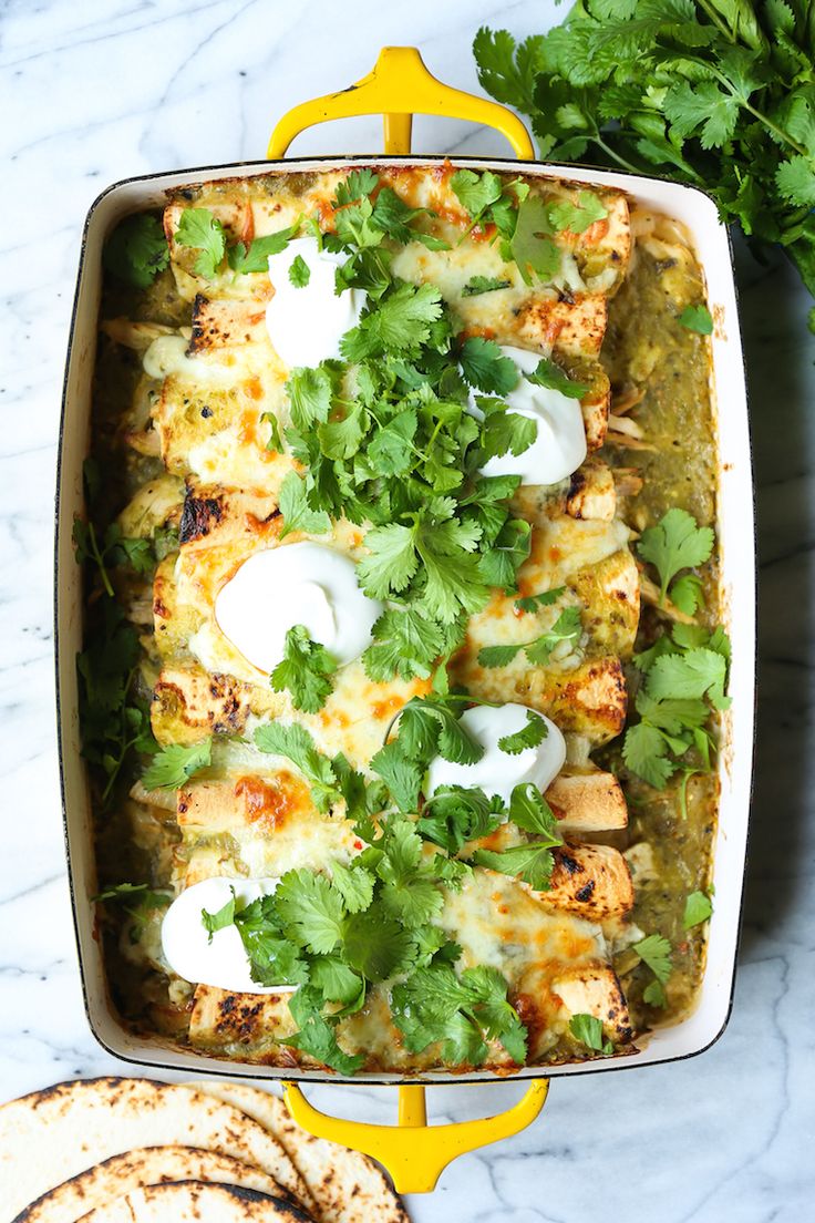 a casserole dish with chicken, cheese and cilantro