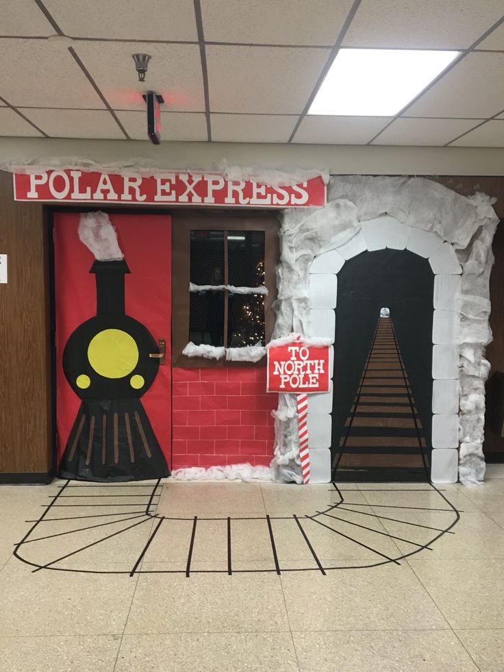 a train themed classroom door decorated with fake snow and paper mache for the holiday season