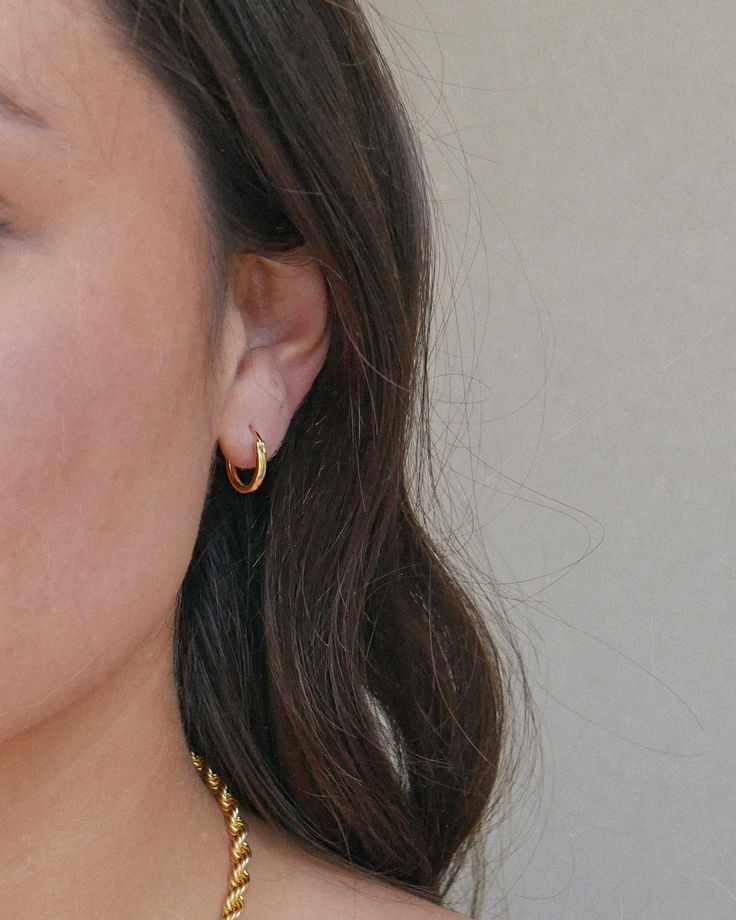 Everybody needs a classic hoop in their collection. This is a mini version of our original Luz hoops! They are perfect for everyday wear and great for styling with other hoops & earrings. Wear these all day, every day but remember to take them off before you shower! THE DETAILS: 18k gold plated high quality sterling silver Can be worn all day long without pain or irritation. Hoop Diameter: 13 mm Hoop Thickness: 1.8 mm Check out our Jewelry Guide to get more info! Trendy Everyday Pierced Wrap Earrings, Trendy Hypoallergenic Hoop Cartilage Earrings, Dainty Hypoallergenic Hoop Earrings, Everyday Single Huggie Earring, Everyday Hypoallergenic Drop Wrap Earrings, Everyday Hypoallergenic Wrap Drop Earrings, Minimalist Hoop Earrings With Lever Back Ear Wires, Everyday Hoop Earrings With Lever Back Ear Wires, Small Hoop Single Wrap Earring Gift