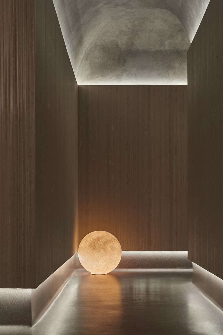 an empty room with a round light on the floor