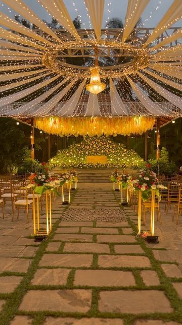 an outdoor wedding venue decorated with lights and decorations