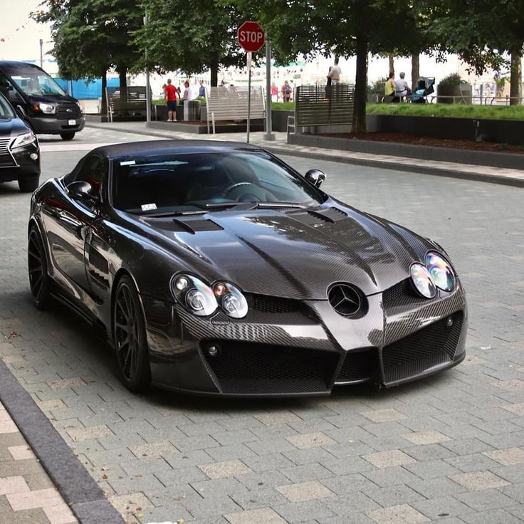 a black sports car is parked on the street