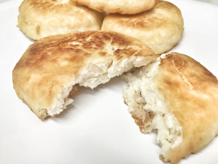 some biscuits are cut in half on a white plate