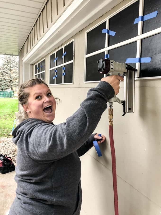 a woman is smiling while holding onto a hose