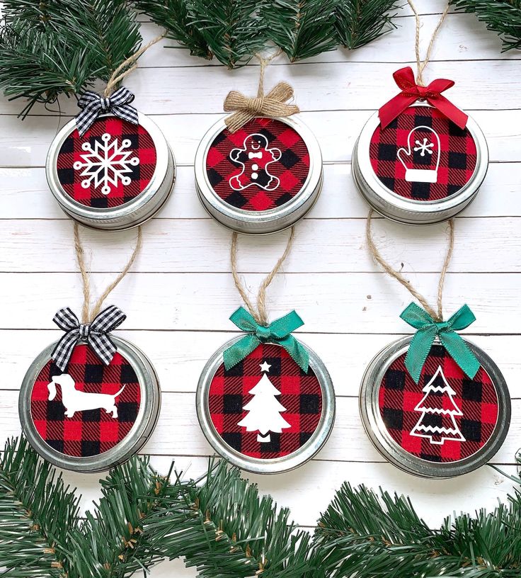 four mason jar ornaments with christmas decorations on them