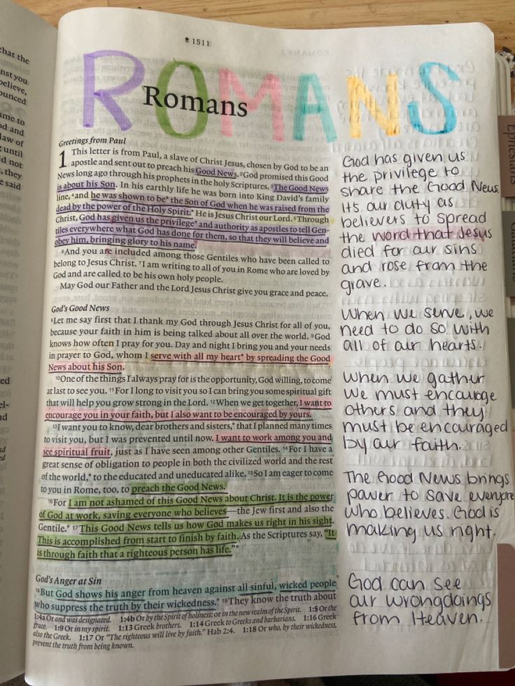 an open bible with the word romans written in multicolored letters on top of it