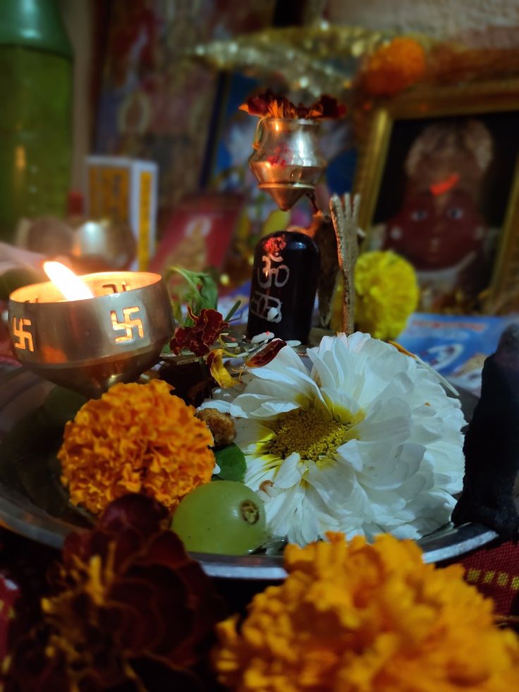 a plate with flowers and candles on it