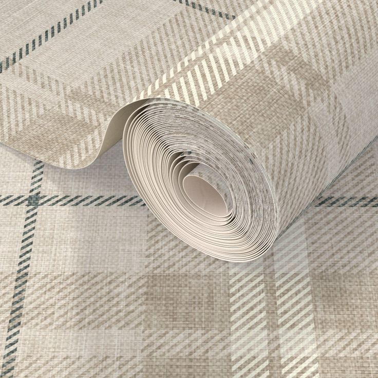 a roll of paper on top of a plaid wallpaper