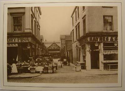 an old black and white photo of people on the street