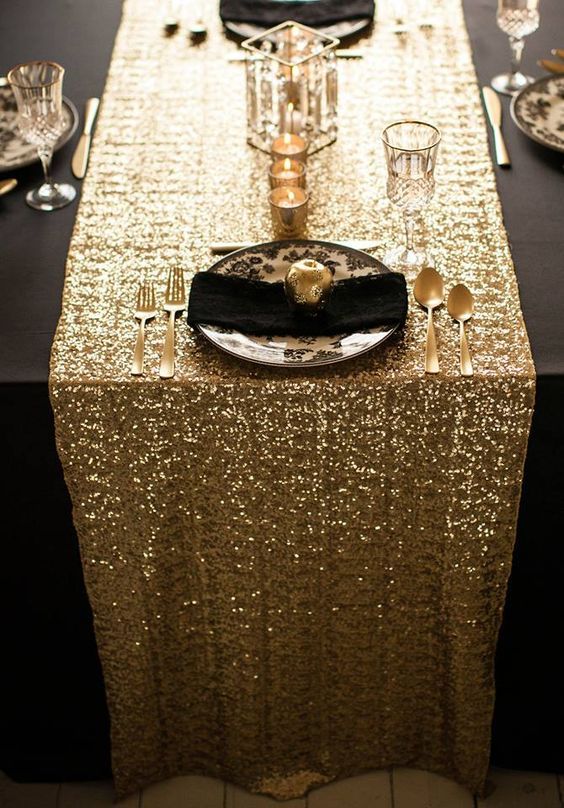 the table is set with gold sequins and place settings