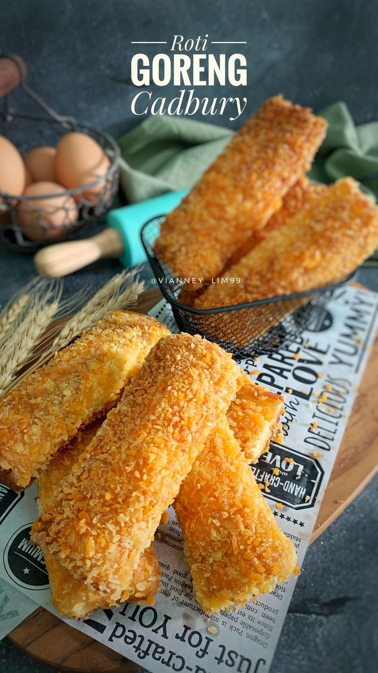 some fried food is sitting on a wooden board next to an egg and bread basket