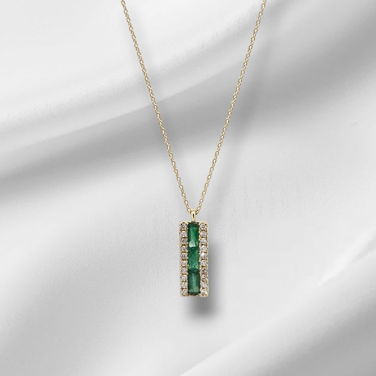 Discover the beauty and elegance of our Emerald and Diamond Necklace. Made with 14k yellow gold, this necklace features stunning emeralds and 0.10ct diamond, adding a touch of luxury to any outfit. The 16-18" chain is secured with a spring ring clasp for ease and comfort. Elevate your style with this timeless piece. 14k Gold Green Necklace With Diamond Accents, Green 14k Gold Necklace With Diamond Accents, Fine Jewelry Green Diamond Necklace In 14k Gold, Green Diamond Necklace In 14k Gold, Elegant Green Diamond Necklace For May Birthstone, Luxury Emerald Diamond Necklace For May Birthstone, Yellow Gold Necklace With Diamond Accents For May Birthstone, Formal Emerald Necklaces With Single Cut Diamonds, Timeless Green Jewelry With Baguette Diamonds