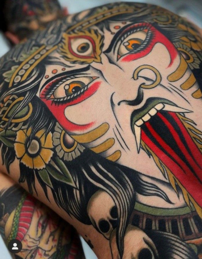 a man with tattoos on his arm and chest is covered in an elaborate tattoo design