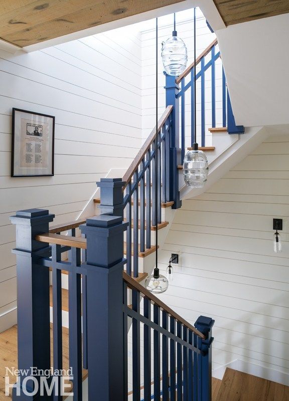 a blue banister next to a wooden staircase