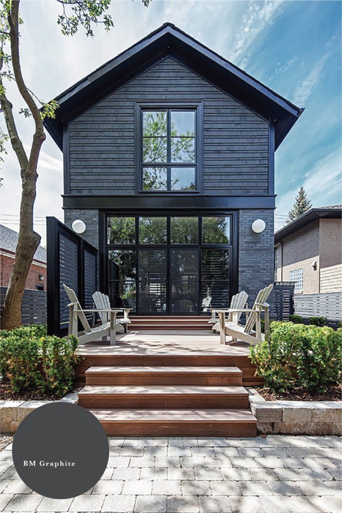 a black house with steps leading up to the front door