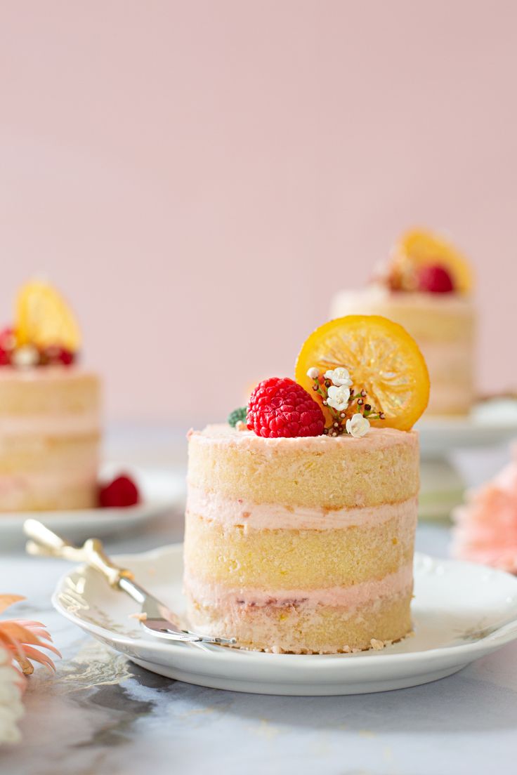 there is a small cake with fruit on the top and other desserts in the background