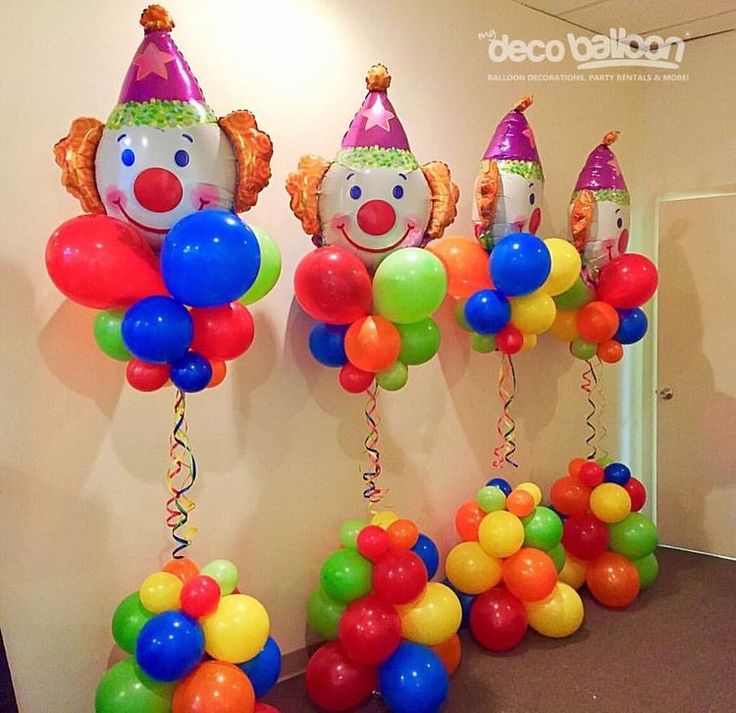 clown balloons are lined up on the wall