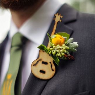 a man wearing a suit and tie with a boutonniere on his lapel