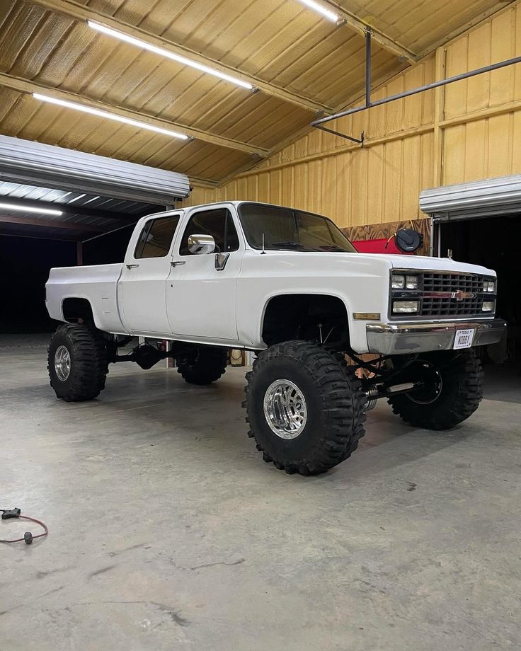 a large white truck parked in a garage