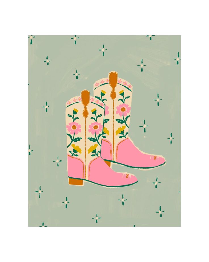 a pair of pink boots with flowers on them are shown in front of a green background