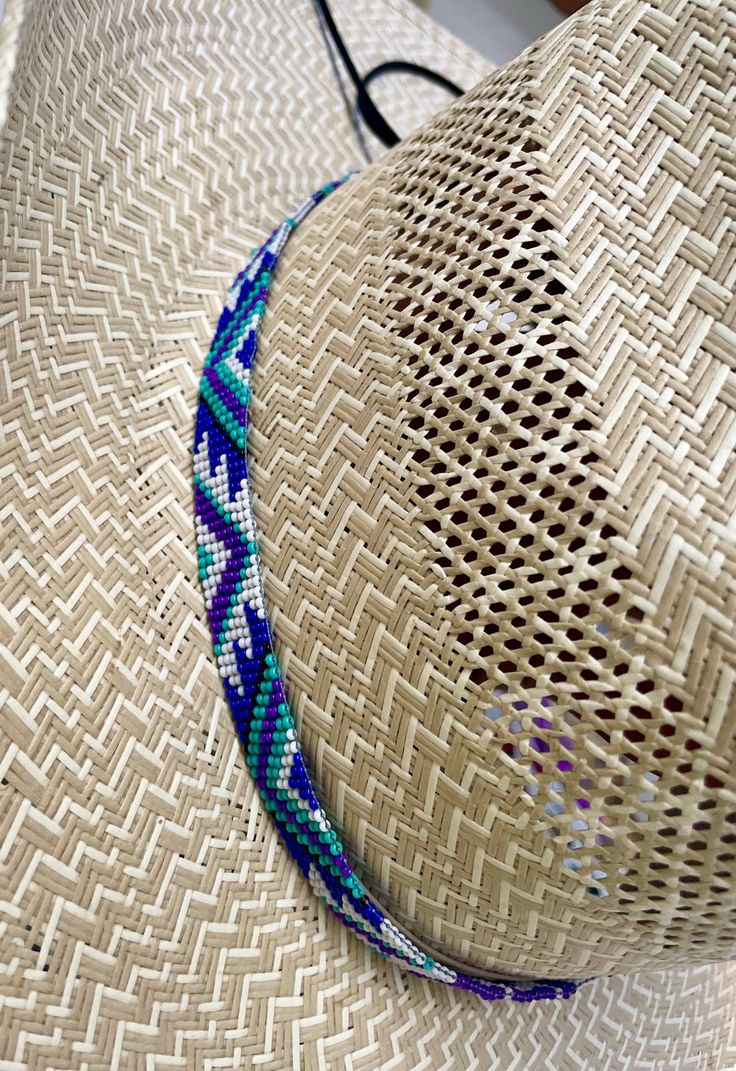 "5/8\" wide All bead work is beaded with 10lb extreme braided nylon line. All hat bands are finished at 23\" with glued than sewed down leather ends and an adjustable leather tie." Southwestern Blue Beaded Hat Band, Handmade Southwestern Blue Hat Band, Blue Beaded Hat Bands For Festival, Handmade Southwestern Blue Hat, Adjustable Multicolor Handwoven Hat Bands, Adjustable Beaded Blue Hat, Adjustable Western Purple Hat, Adjustable Blue Beaded Hat, Adjustable Handmade Purple Hats