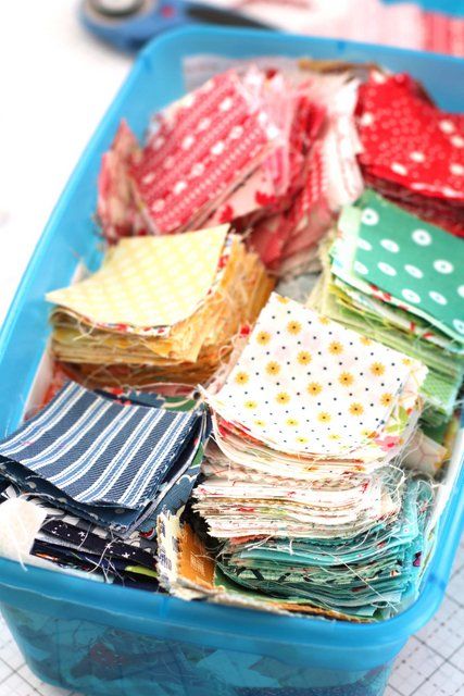 a blue container filled with lots of different types of fabric