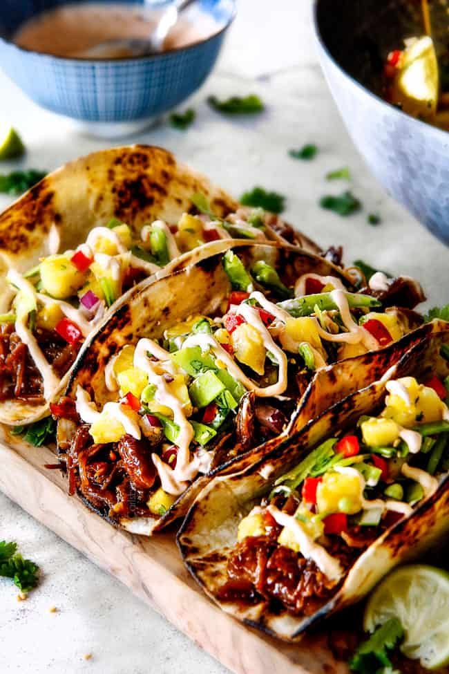 some tacos are sitting on a cutting board